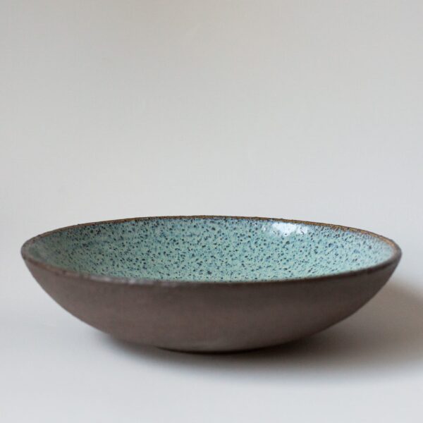 Deep turquoise plate made from dark chamotte